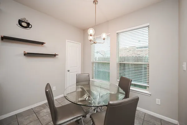 a dining room with furniture and window