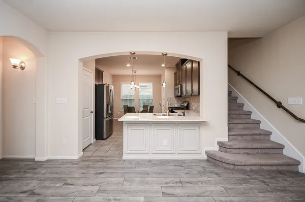 a view of entryway and hall with a front door