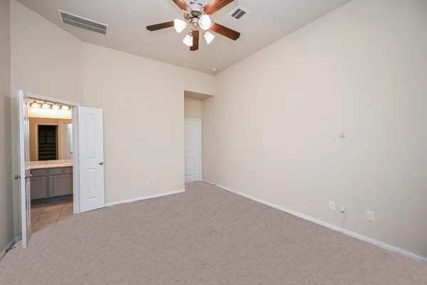 a view of an empty room with a ceiling fan