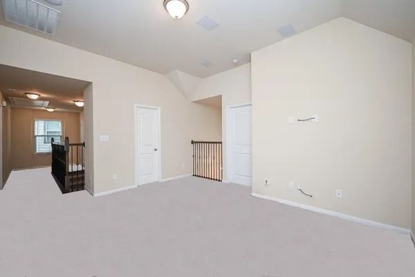 a view of a big room with closet and windows