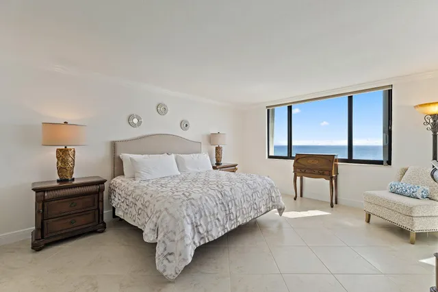 a bedroom with a bed and a flat screen tv on dresser