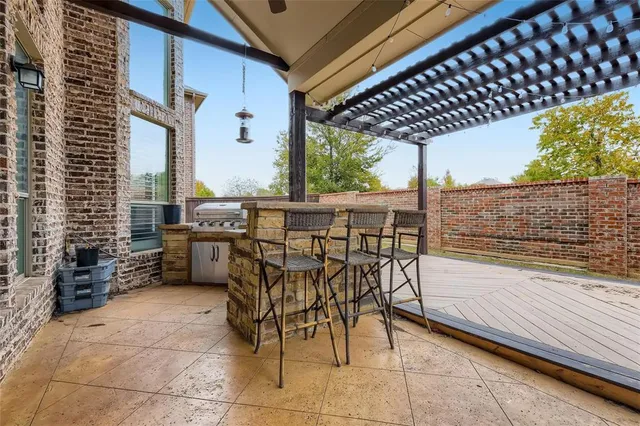 a patio with glass top table and chairs