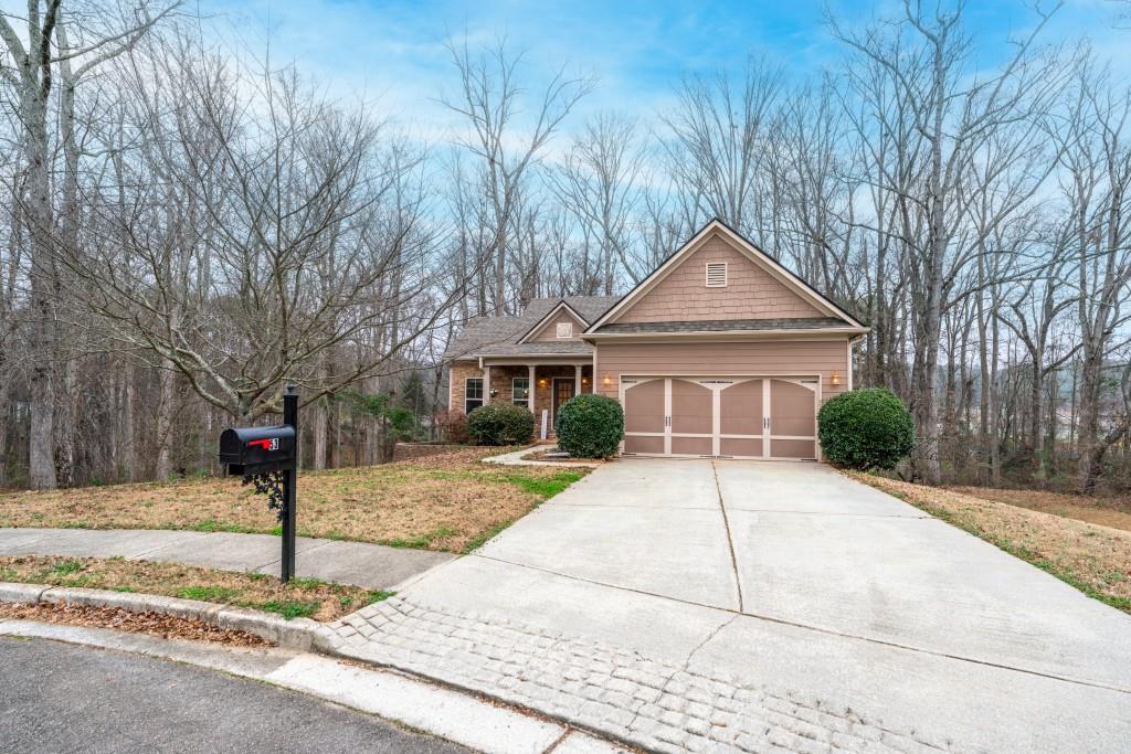 a front view of a house with a yard and trees