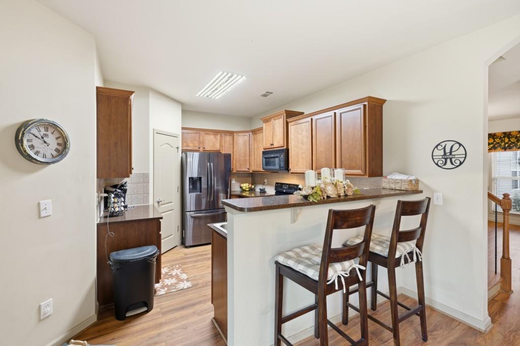 53 Bobbin Court Jefferson, GA 30549 - Photo 19 of 40 a kitchen with stainless steel appliances granite countertop a table chairs and a refrigerator