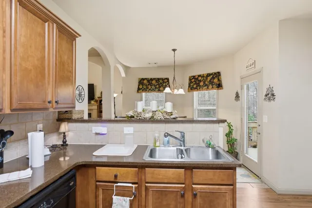 a kitchen with stainless steel appliances granite countertop a sink and a counter space