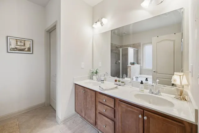 a bathroom with a double vanity sink and a mirror
