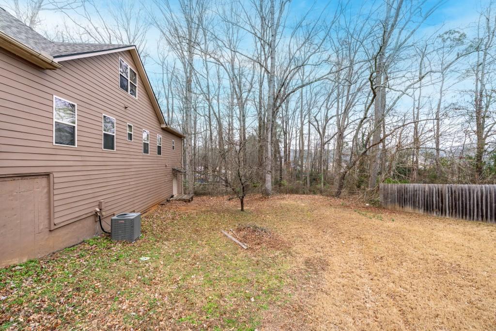 53 Bobbin Court Jefferson, GA 30549 - Photo 40 of 40 a backyard of a house with lots of plants and tree