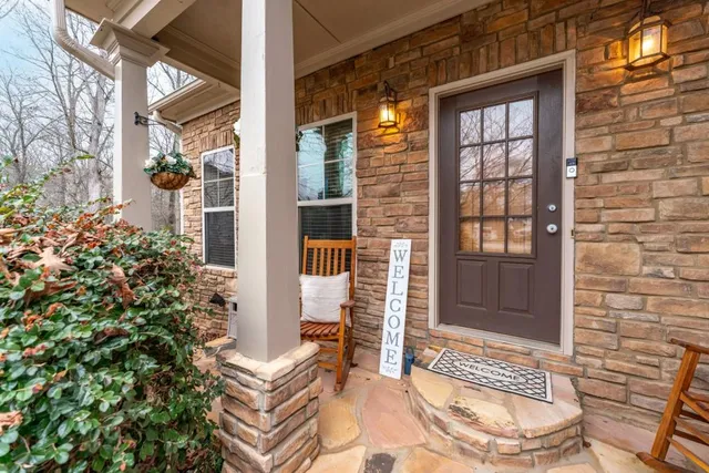 front view of a brick house with a large windows
