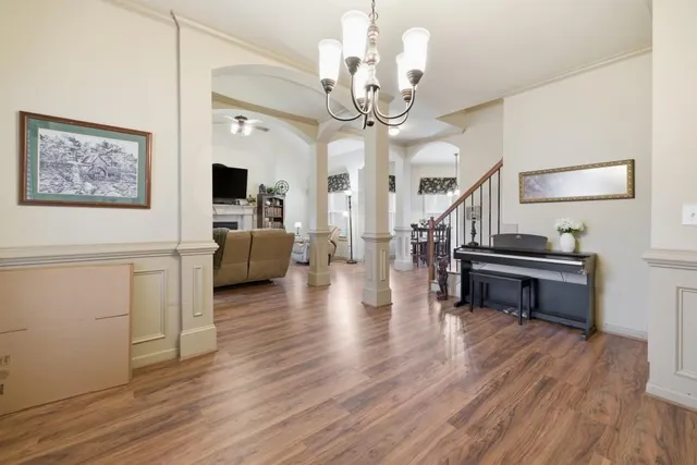 a living room with furniture and a wooden floor