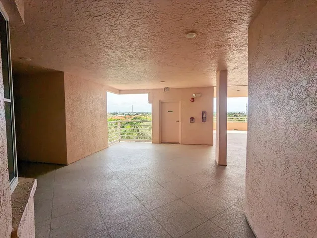 a living room with furniture and large windows