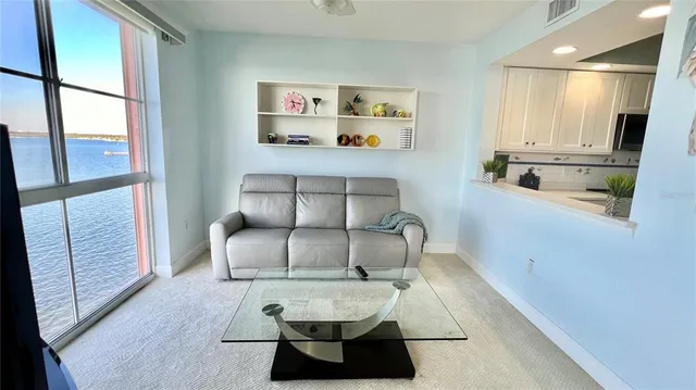 a view of a hallway with furniture and a large window