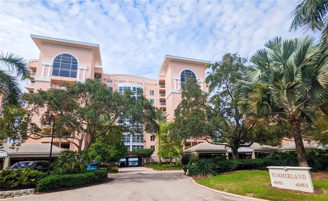 a view of a house with a yard and potted plants