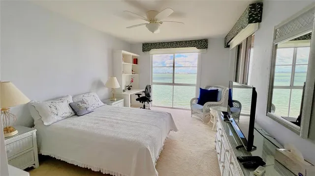 a bedroom with two beds and a painting on the wall