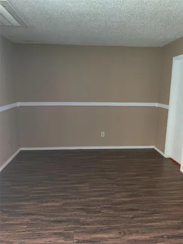 a view of a room with wooden floor