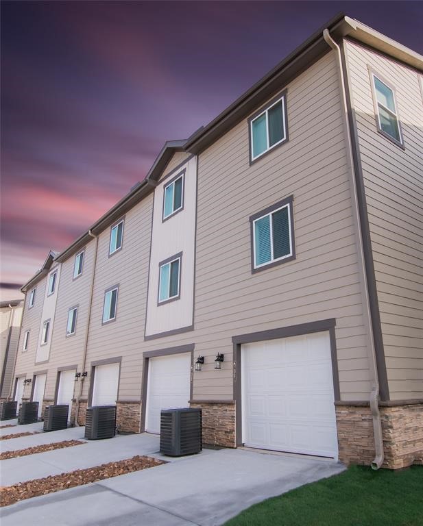 12603 Telge Road, Unit 4C Cypress, TX 77429 - Photo 12 of 16 a front view of a house with a yard and garage