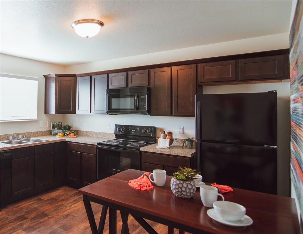 12603 Telge Road, Unit 4C Cypress, TX 77429 - Photo 3 of 16 a kitchen with a sink refrigerator and cabinets
