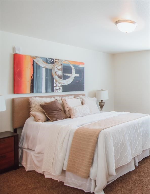 12603 Telge Road, Unit 4C Cypress, TX 77429 - Photo 6 of 16 a bedroom with a bed and painting on the wall