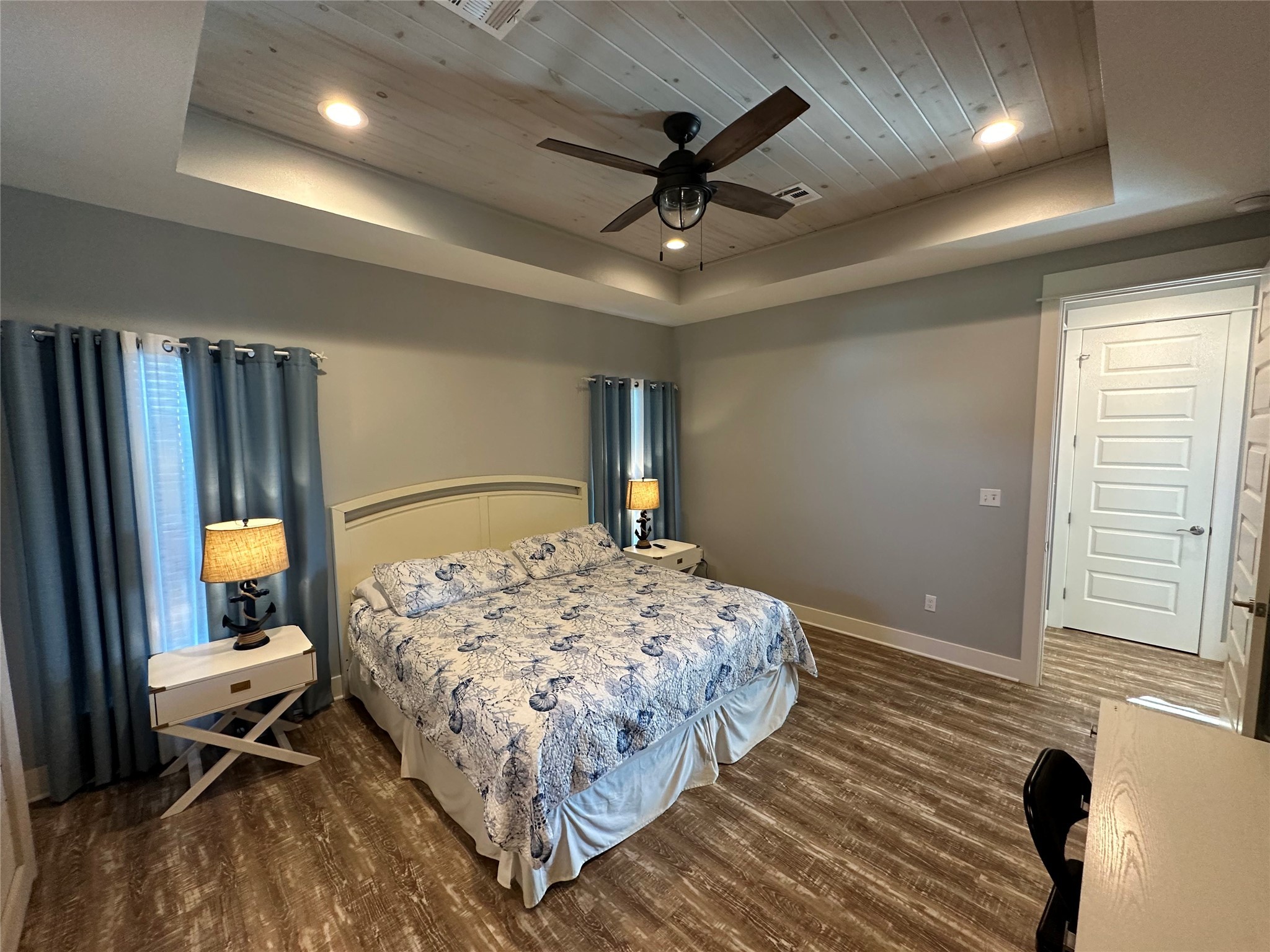 2429 Sand Castle Crystal Beach, TX 77650 - Photo 33 of 46 a bedroom with a bed ceiling fan and a wooden floor