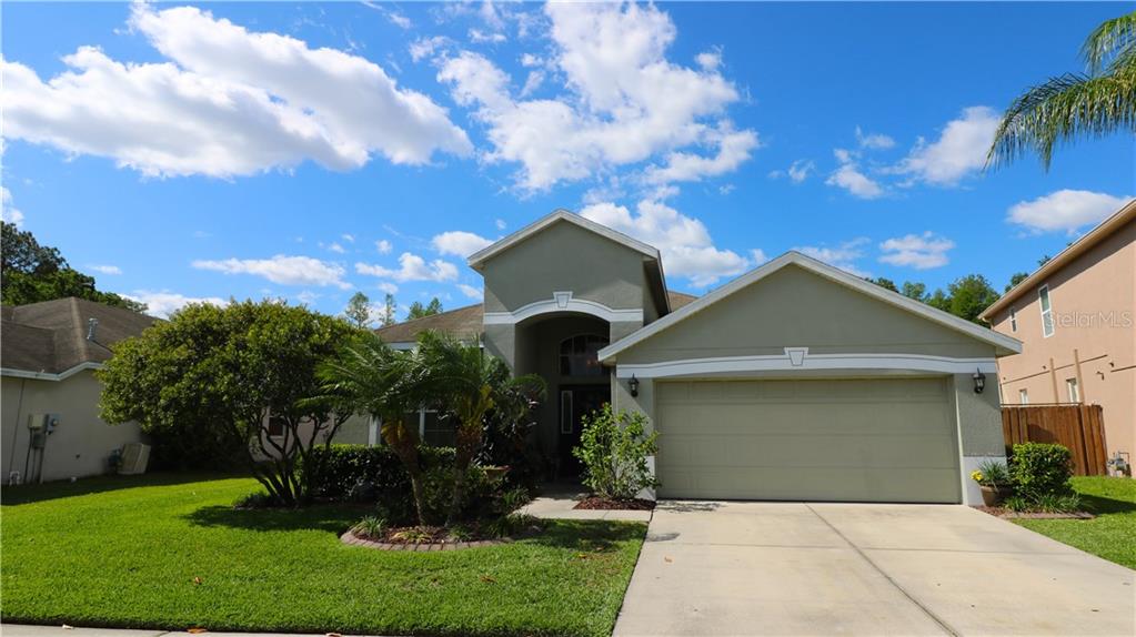 4526 Mapletree Loop Wesley Chapel, FL 33544 - Photo 1 of 1 front with beautiful landscaping