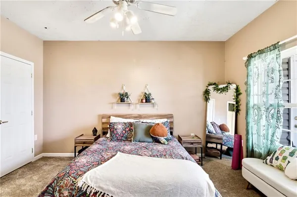 a bedroom with bed and flat screen tv