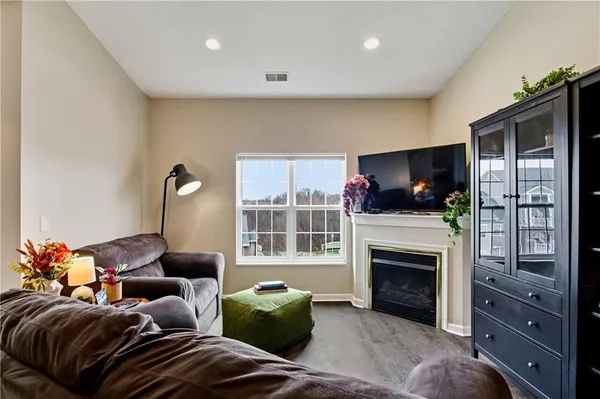 a living room with furniture a flat screen tv and a fireplace
