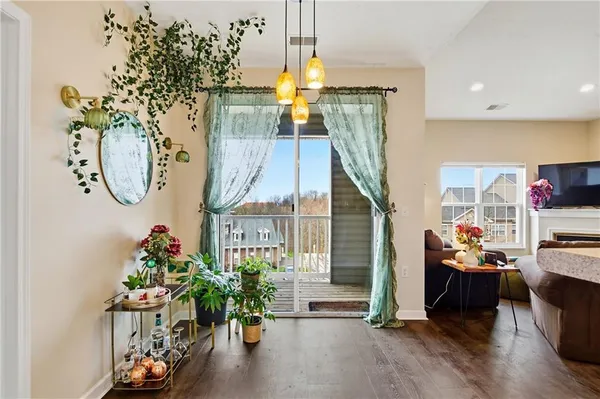a living room with furniture a ceiling fan and a flat screen tv