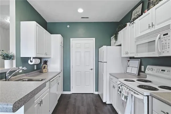 a kitchen with a sink cabinets and refrigerator