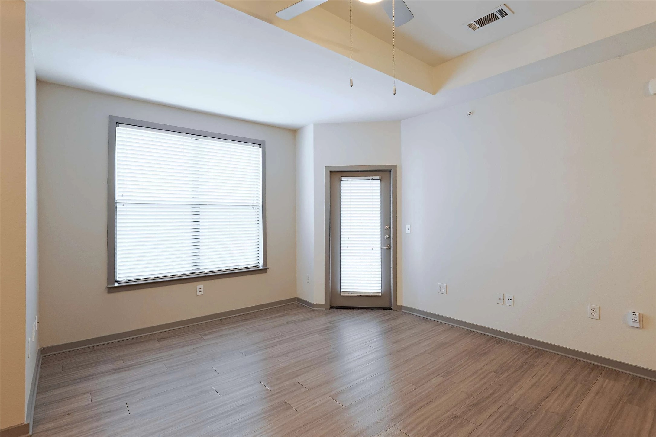 8515 Interstate 35, Unit 17239 Austin, TX 78744 - Photo 17 of 20 an empty room with wooden floor and windows