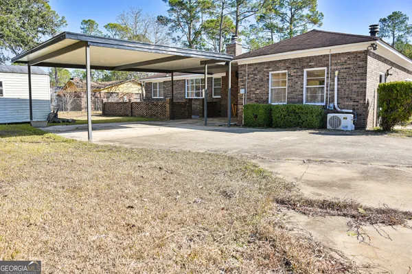 a view of a house with a yard and porch