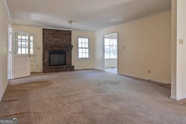 a view of empty room with a fireplace
