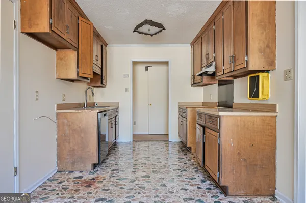 a utility room with closet a stove and a window