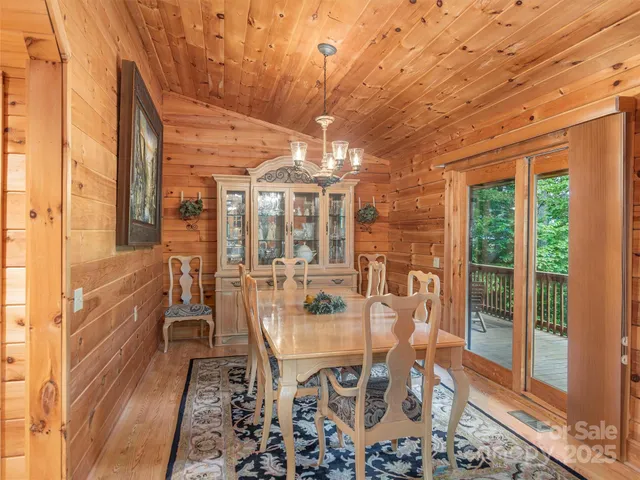 a view of a dining room with furniture wooden floor and a chandelier