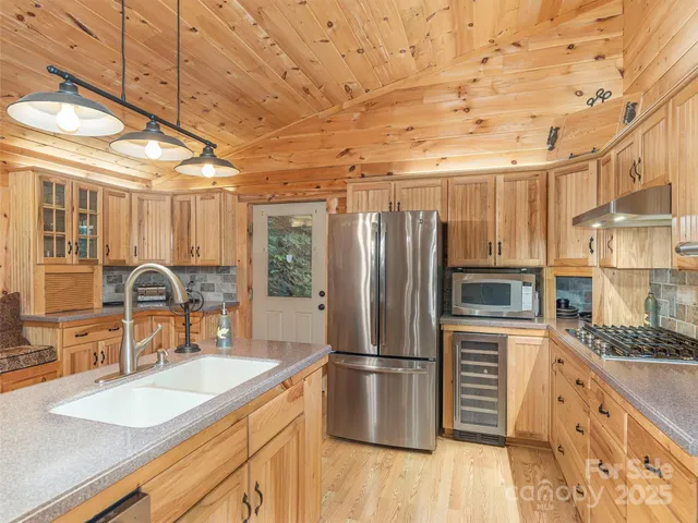 a kitchen with refrigerator and cabinets