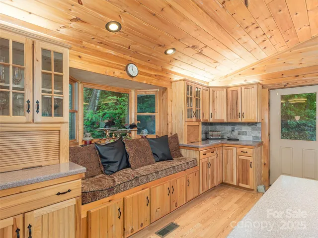 a large kitchen with granite countertop a sink and cabinets