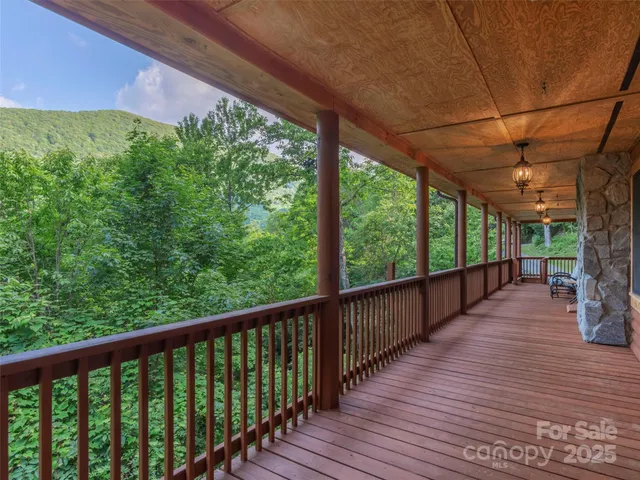 a view of a porch with wooden floor in front of house