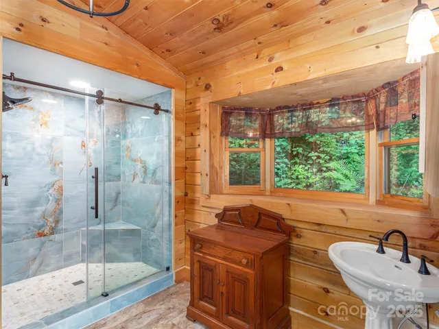 a bathroom with a sink a toilet and a shower