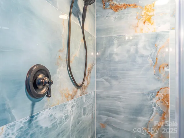 a bedroom with furniture and large windows