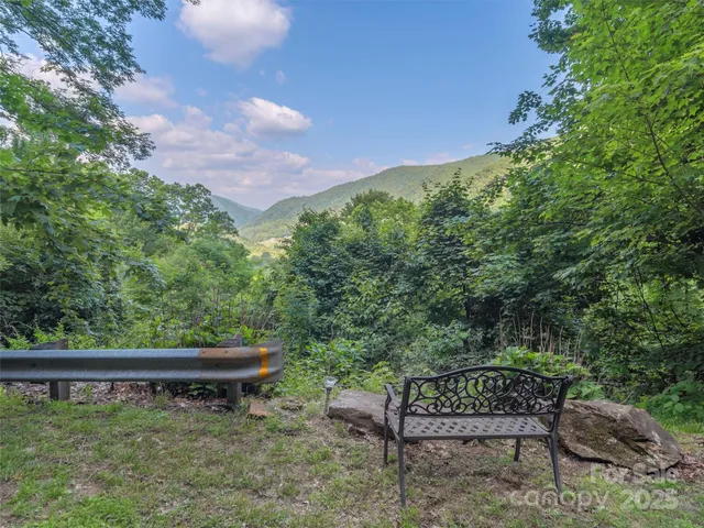 an aerial view of a house with a yard table and chairs