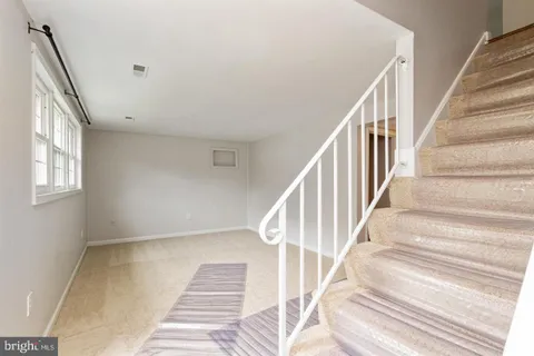 a view of staircase with white walls and windows