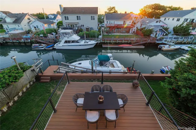 a view of a lake with a table and chairs
