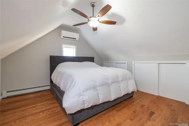 a bedroom with a bed and a ceiling fan