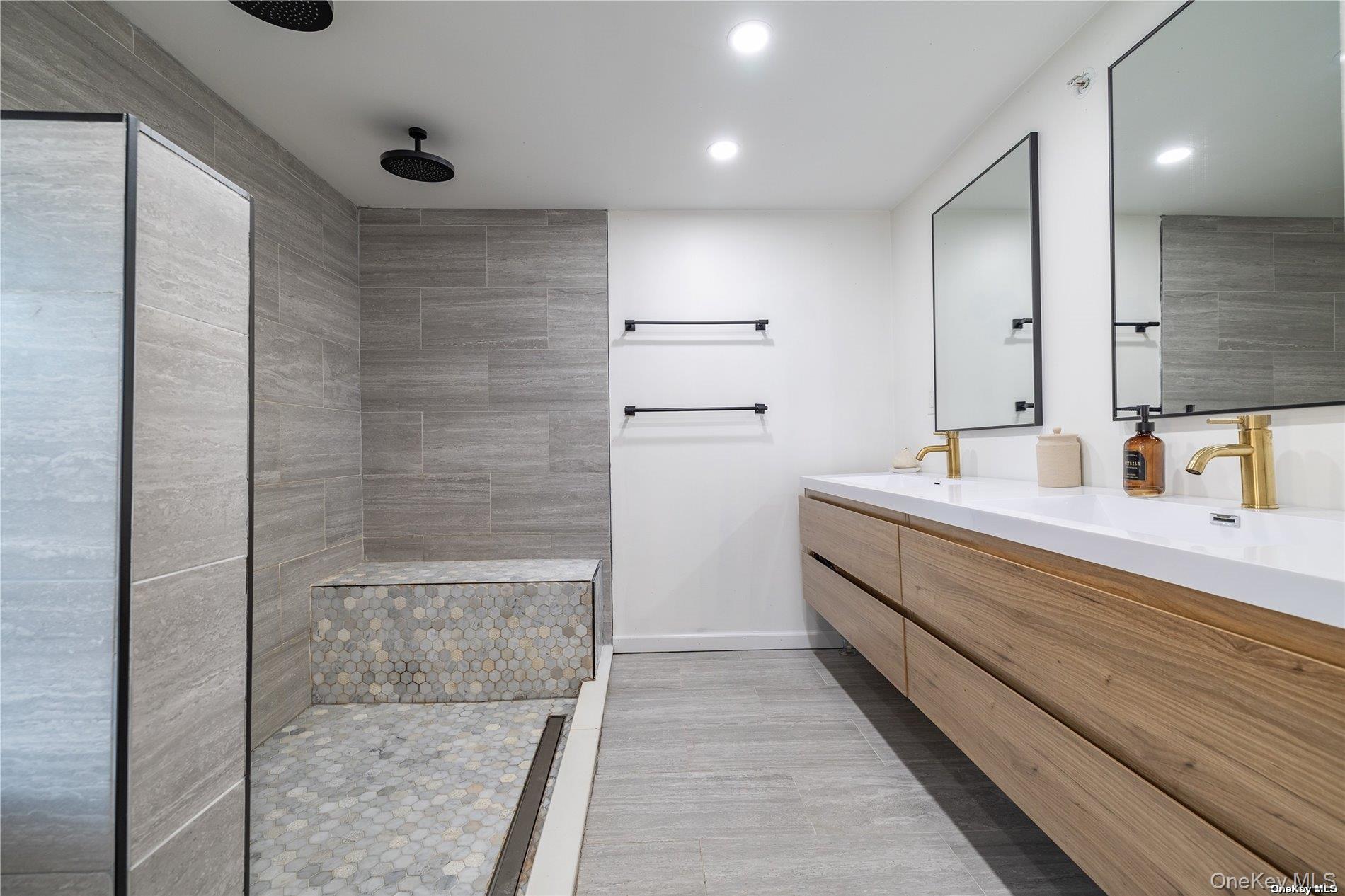 308 Bedell Street Freeport, NY 11520 - Photo 14 of 29 a bathroom with a double vanity sink a toilet and shower