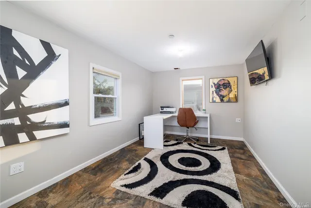 a room with a bed and a wooden floor