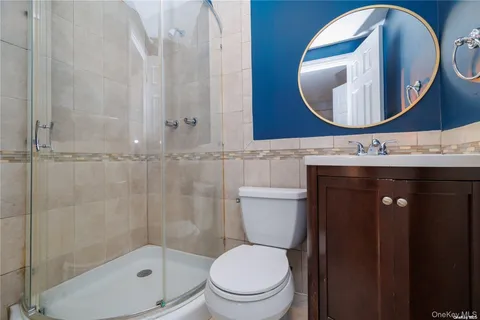 a bathroom with a toilet a sink and mirror