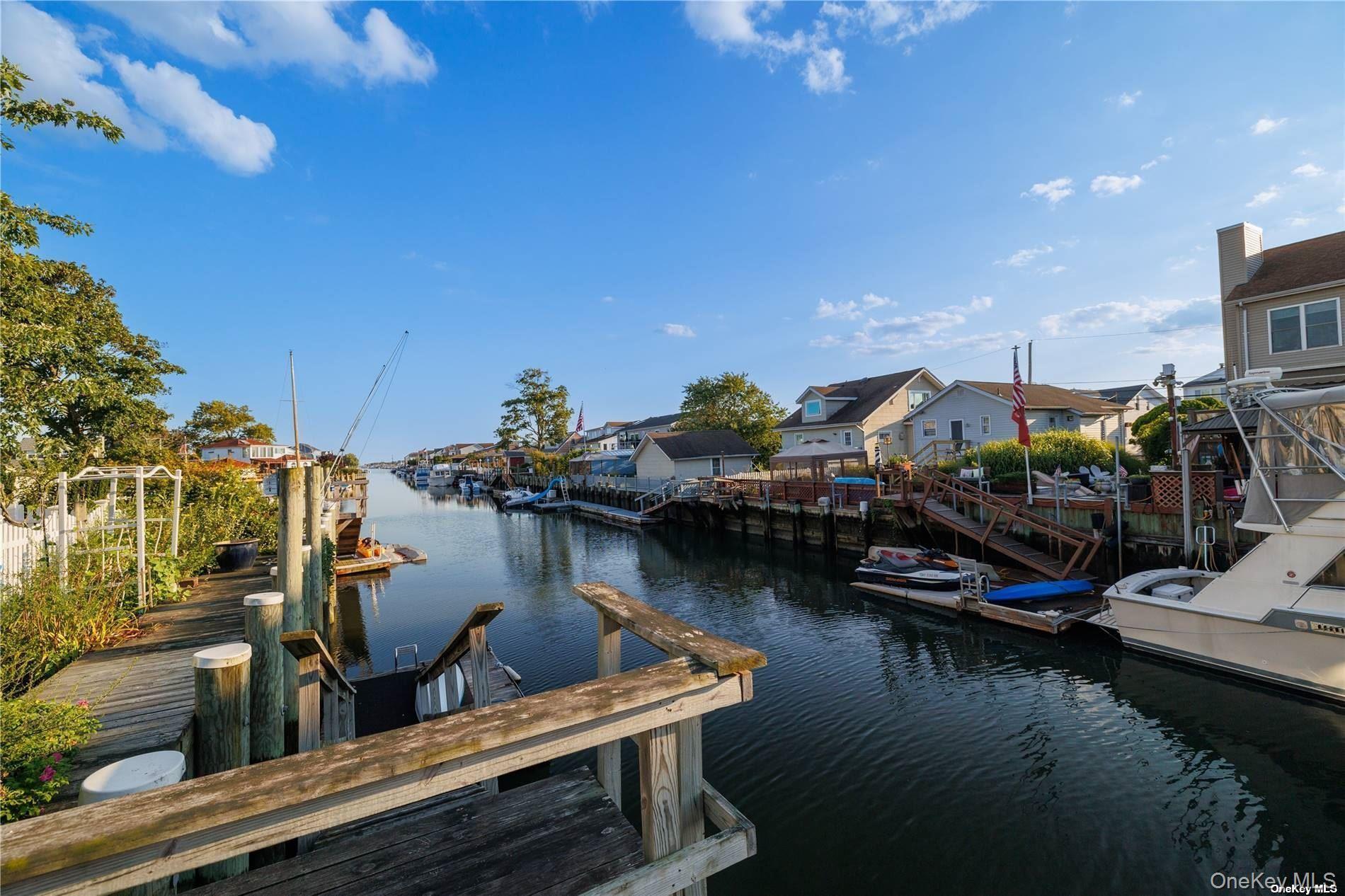 308 Bedell Street Freeport, NY 11520 - Photo 26 of 29 a view of a lake with boats and trees