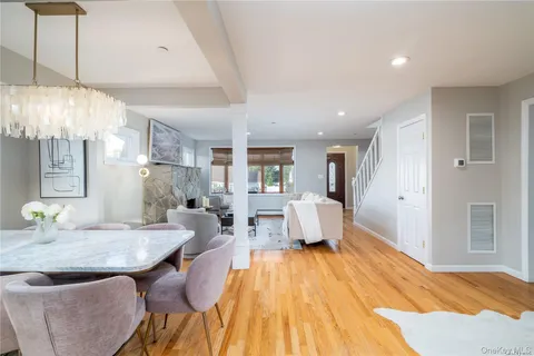 a spacious bedroom with a bed and chandelier