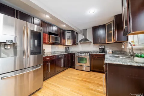 a kitchen with stainless steel appliances granite countertop a refrigerator stove and oven