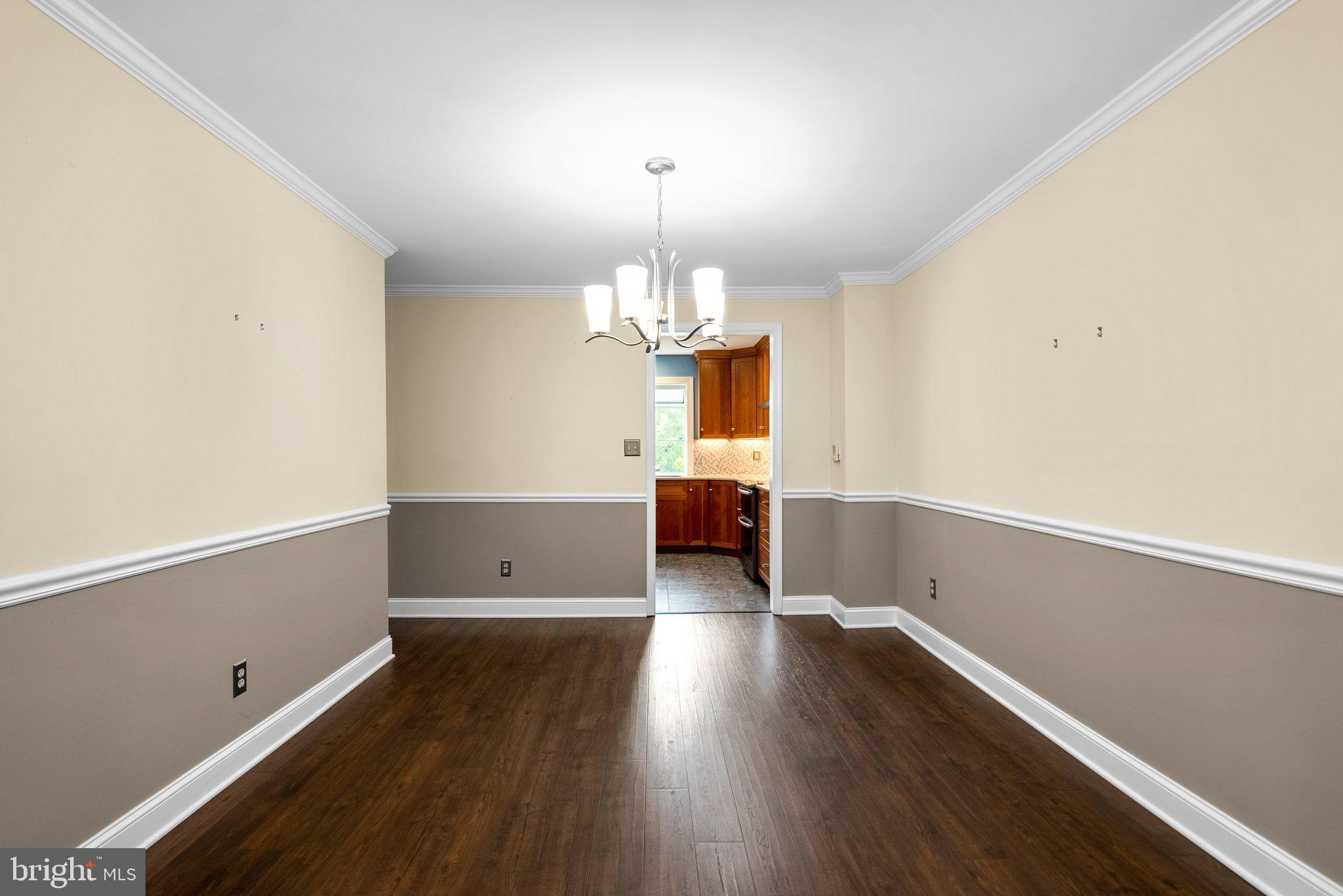 57 Oak Shade Road Gaithersburg, MD 20878 - Photo 8 of 39 Formal Dining Room with Chandelier and Moldings