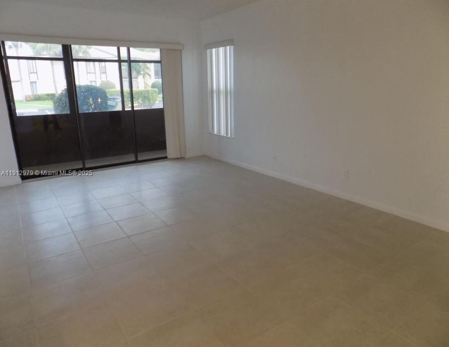 824 Sky Pine Way, Unit A1 West Palm Beach, FL 33415 - Photo 3 of 9 an empty room with windows