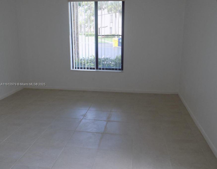824 Sky Pine Way, Unit A1 West Palm Beach, FL 33415 - Photo 5 of 9 an empty room with a window